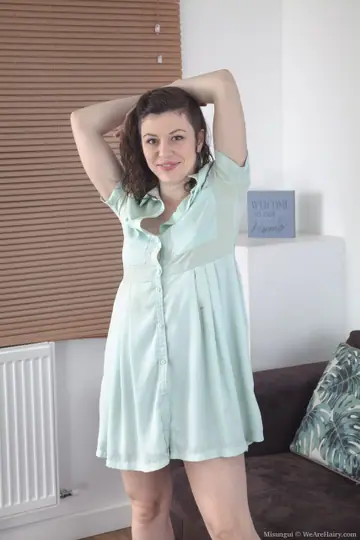 Hairy Brunette Spreads Her Pussy on the Sofa in Heels