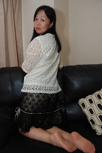 Mature Asian Woman Strips Out of Her Skirt and Pantyhose