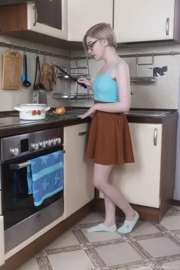 Short-Haired Blonde in Socks and Glasses Spreads in the Kitchen