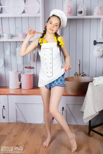 Skinny Woman in a Skirt Strips and Spreads in the Kitchen
