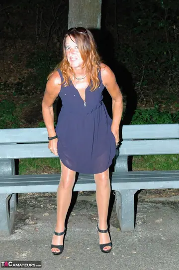 Mature European Woman Spreads Her Legs on a Park Bench Beside a Car
