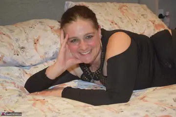 Mature BBW in Stockings Shows Her Big Tits on the Bed