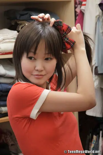 Asian Woman in Uniform Strips and Masturbates in Pigtails