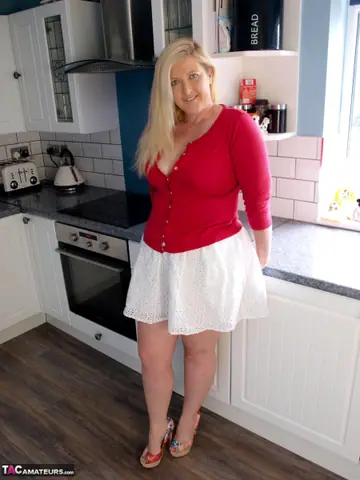 Curvy Blonde MILF Strips and Spreads in the Kitchen