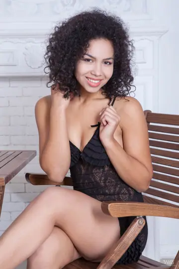 Curly Ebony Woman Spreads Wide on a Chair