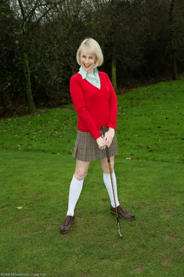 Hazel May – Mature Blonde in Golf Uniform Spreads Her Hairy Pussy Outdoors