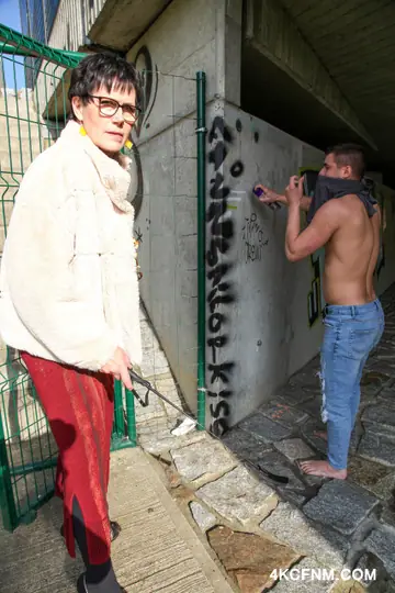 Georgina C – Short-Haired Woman in a Skirt and Glasses Gives a Handjob Outdoors