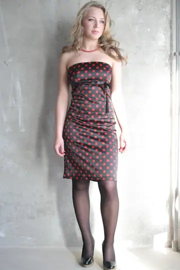 Curly Babe in a Dress and Stockings Shows Off Her Big Tits