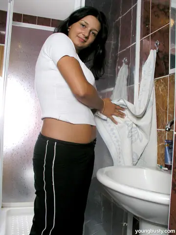 Thick Brunette Strips Out of Her Panties in the Bathroom