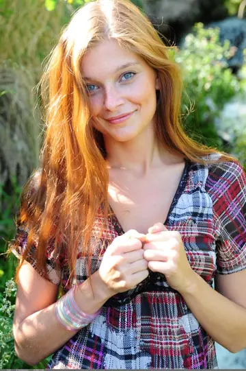 Slim Redhead Undresses on the Beach Near a Waterfall