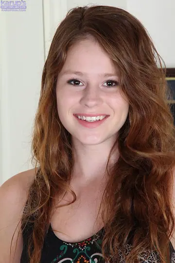 Redhead in a Skirt Spreads Her Shaved Pussy