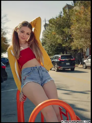 Lana Lea – Blonde in Shorts Strips Naked and Holds Her Pigtails