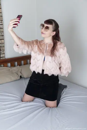 Woman in a Skirt Pulls Panties Aside and Fingers Herself