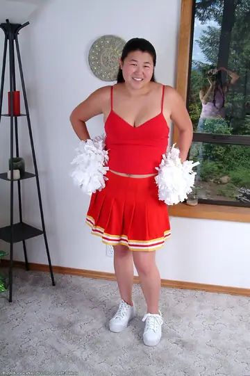 Chubby Asian Woman Sheds Her Cheer Uniform to Spread Her Hairy Pussy