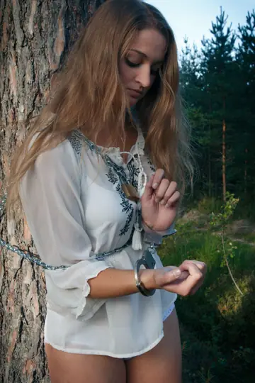 Blonde Lesbian in Bondage Plays with Hairy Pussy in the Forest