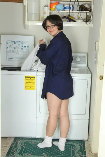 Carlita Johnson – Tattooed Brunette MILF Undresses in Laundry Room Keeping Glasses On