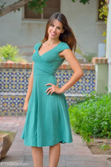 Slim Brunette in a Dress Poses Outdoors and in the Kitchen