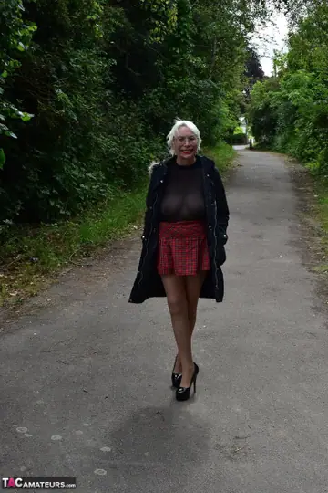 Mature Blonde in a Skirt and Heels Spreads Outdoors