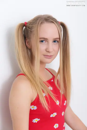 Blonde in Shorts Spreads with Long Pigtails
