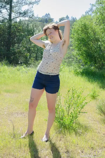Slim Redhead Strips Nude and Spreads Her Hairy Pussy Outdoors
