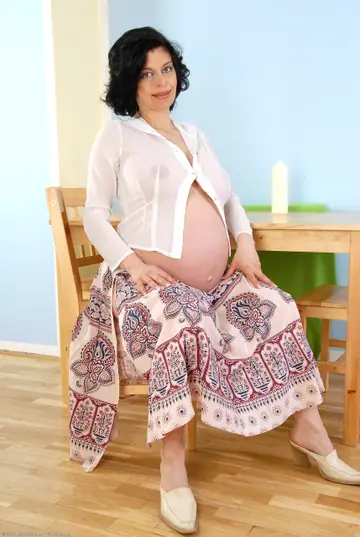 Pregnant Mature Brunette Strips Off Her Skirt and Fingers Her Hairy Pussy