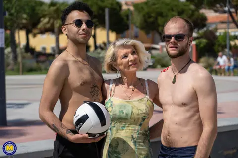 Mature Blonde Sucks Two Cocks in a Public Threesome – photo 3 of 11