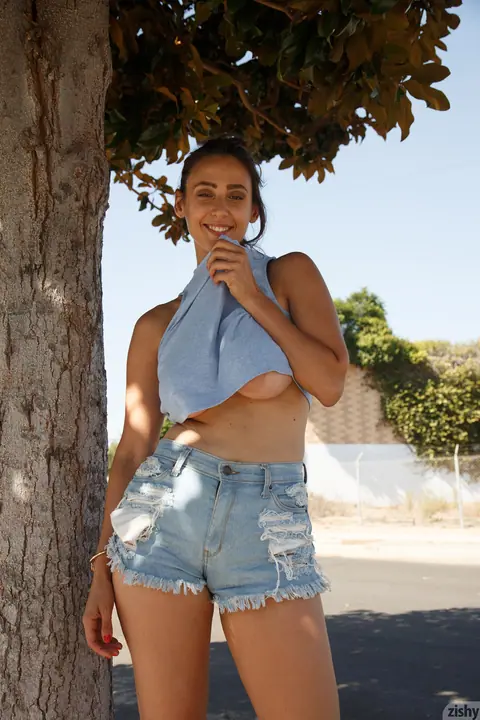 Rhonda Biasi: Busty Brunette Pulls Shorts Aside and Spreads Her Legs Outdoors – photo 4 of 11