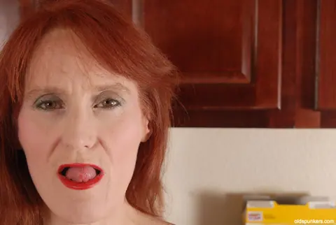Redhead Granny Fingers Her Shaved Pussy – photo 1 of 16
