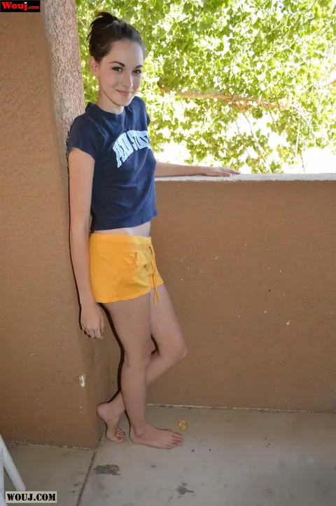 Emily Grey: Brunette Amateur Shows Off Her Curves in Shorts on a Balcony – photo 4 of 15