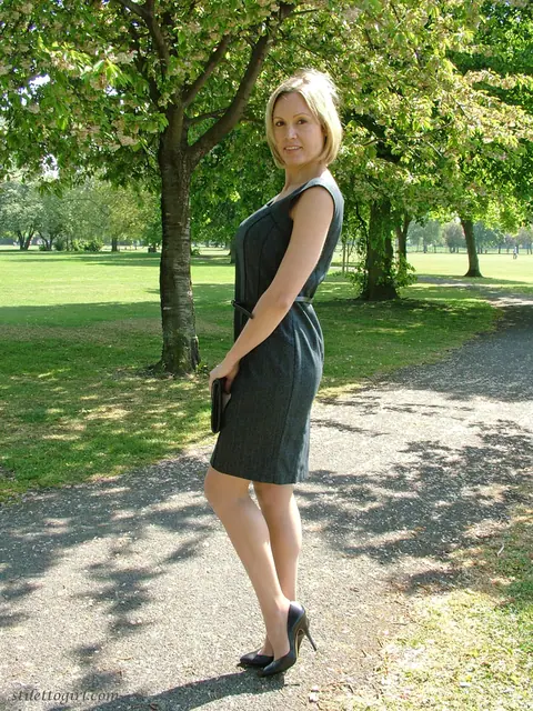 Mature Blonde Woman in a Skirt and High Heels Poses Outdoors – photo 12 of 16