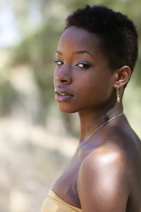 Ebony Woman with Short Hair Poses Fully Clothed – photo 11 of 20