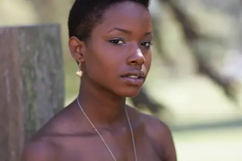 Ebony Woman with Short Hair Poses Fully Clothed – photo 4 of 20