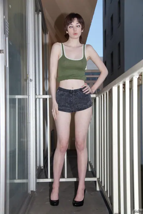 Lilly Gardner: Redhead Strips on the Balcony and Sofa – photo 4 of 11